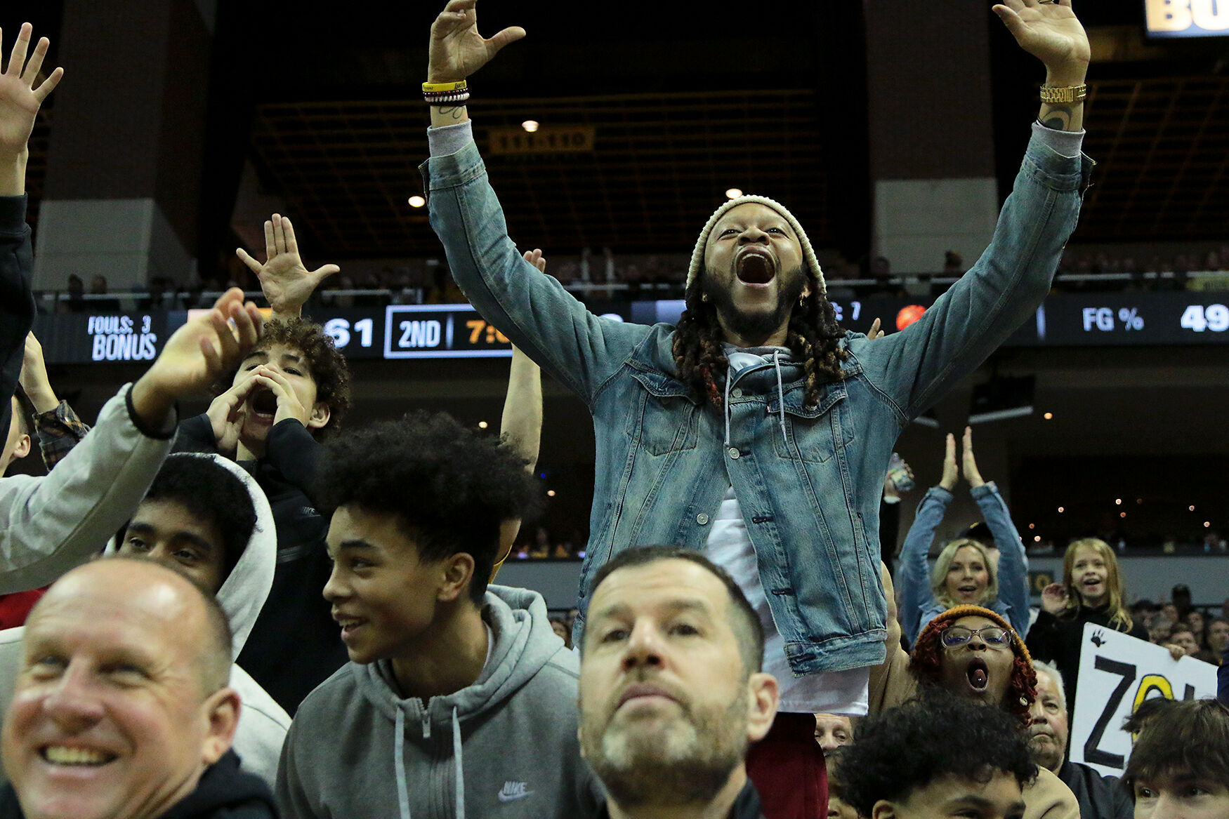 Fans in the stands cheer during the second half